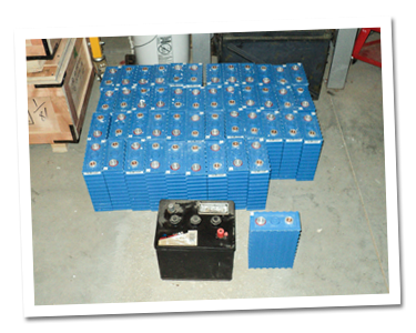Old golf cart battery in from of the new lithium ion batteries Old golf cart battery in from of the new lithium ion batteries